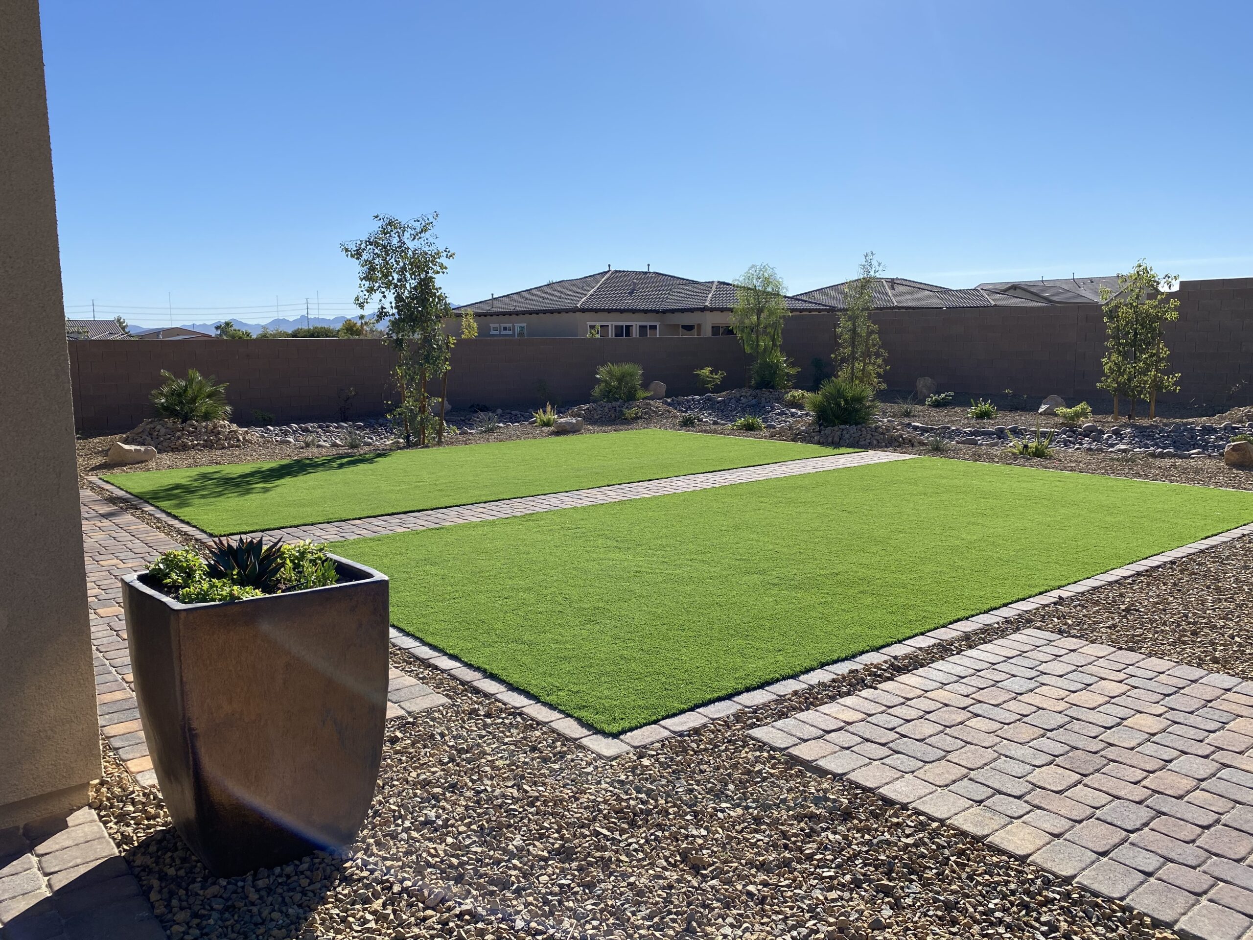 Finished artificial turf backyard with pavers